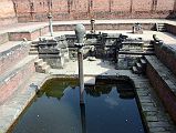 Kathmandu Bhaktapur 05-1 Bhaktapur Durbar Square Naga Pokhari The Naga Pokhari (Snake Pond) in the Palace of 55 Windows in Bhaktapurs Durbar Square is a 17C royal water tank encircled by a writhing stone cobra. The nagas rise up on scaled pillars.